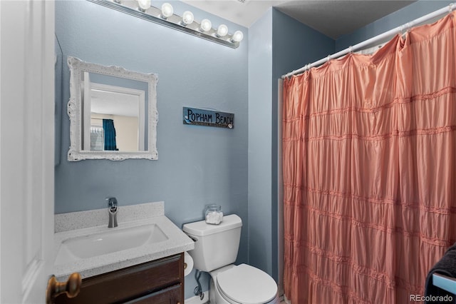 bathroom featuring vanity, toilet, and a shower with shower curtain