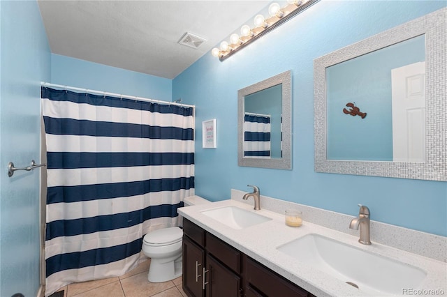 bathroom featuring vanity, toilet, tile patterned floors, a textured ceiling, and a shower with curtain