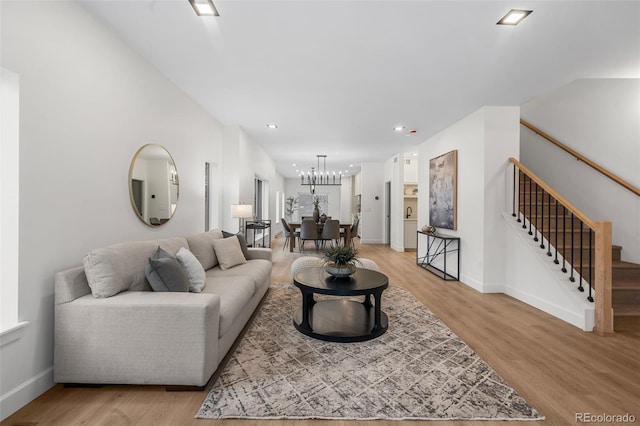 living room featuring stairway, recessed lighting, light wood-style flooring, and baseboards