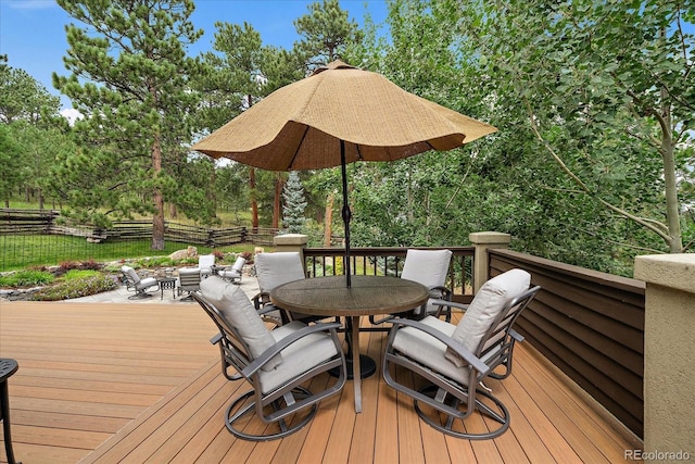 1456 Shavano Ct, Evergreen, CO 80439 - deck with outdoor dining area and view of wooded area
