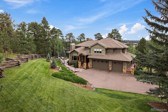 1456 Shavano Ct, Evergreen, CO 80439 - view of front of home with stone siding, a garage, a chimney, driveway, and a shingled roof