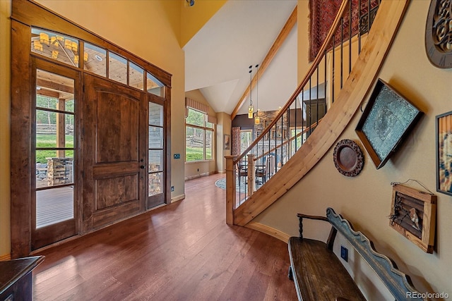 1456 Shavano Ct, Evergreen, CO 80439 - foyer entrance with stairs, healthy amount of natural light, wood finished floors, and lofted ceiling