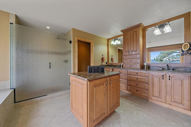 1456 Shavano Ct, Evergreen, CO 80439 - kitchen with light tile patterned floors, a center island, and dark stone counters