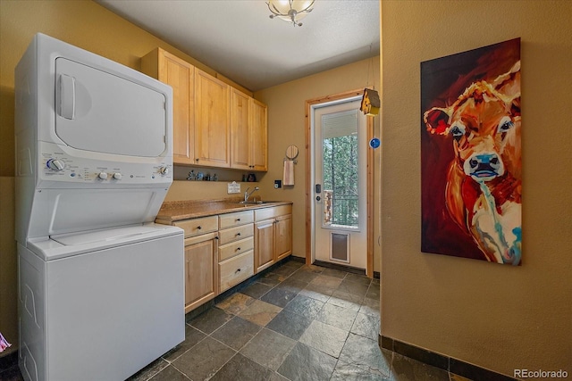 1456 Shavano Ct, Evergreen, CO 80439 - laundry area featuring stacked washer / drying machine and stone tile flooring
