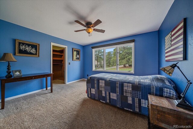 1456 Shavano Ct, Evergreen, CO 80439 - carpeted bedroom featuring a spacious closet and a ceiling fan