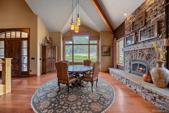 1456 Shavano Ct, Evergreen, CO 80439 - dining room with vaulted ceiling, wood finished floors, and a fireplace