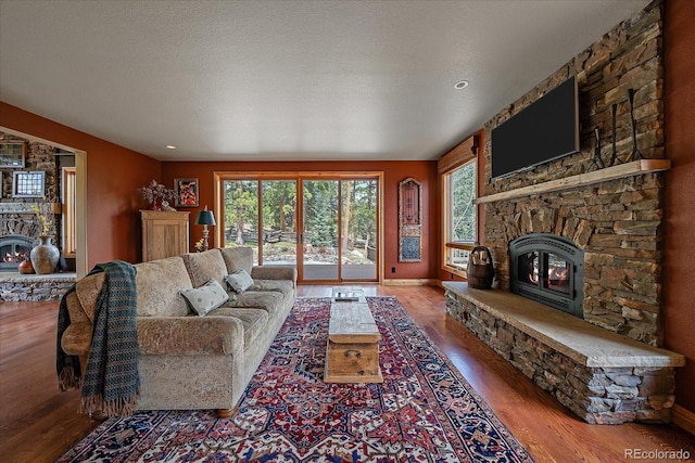 1456 Shavano Ct, Evergreen, CO 80439 - living area with a stone fireplace and wood finished floors