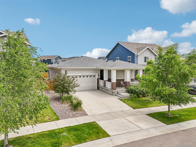 5928 N Odessa St, Aurora, CO 80019 - view of front of home featuring covered porch, a garage, driveway, brick siding, and board and batten siding