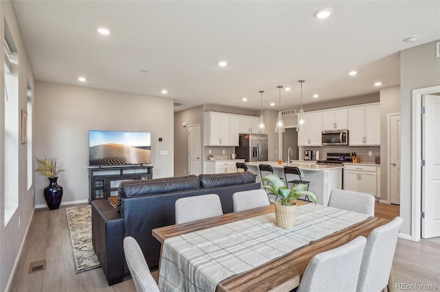 5928 N Odessa St, Aurora, CO 80019 - dining area featuring recessed lighting, light wood finished floors, and baseboards