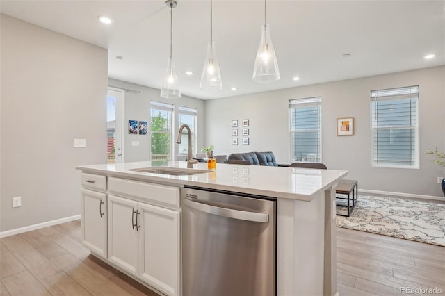 5928 N Odessa St, Aurora, CO 80019 - kitchen with dishwasher, a sink, light wood-style floors, open floor plan, and an island with sink