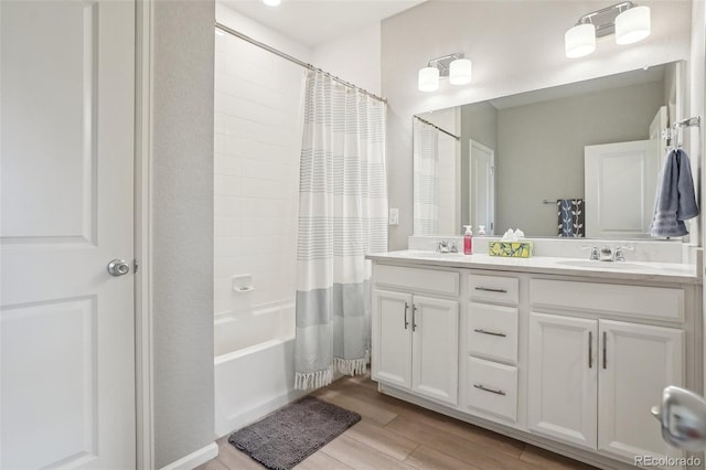 5928 N Odessa St, Aurora, CO 80019 - full bathroom with double vanity, wood finished floors, and shower / tub combo