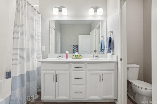 5928 N Odessa St, Aurora, CO 80019 - bathroom featuring double vanity and toilet