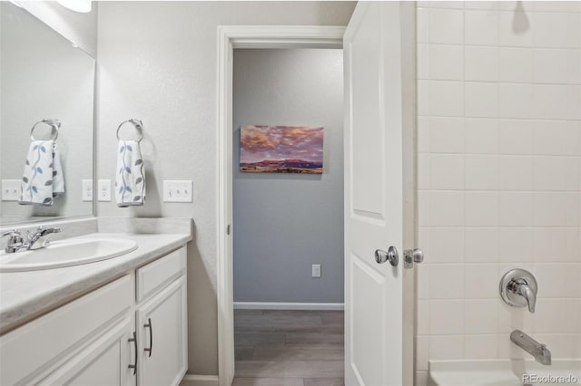 5928 N Odessa St, Aurora, CO 80019 - bathroom with vanity, wood finished floors, shower / bath combination, and baseboards