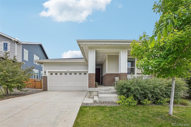 5928 N Odessa St, Aurora, CO 80019 - view of front of home with brick siding, a garage, driveway, and covered porch