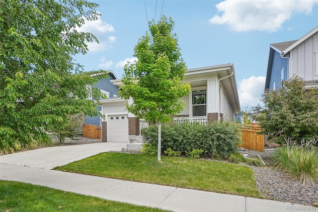 5928 N Odessa St, Aurora, CO 80019 - view of property hidden behind natural elements with concrete driveway, brick siding, an attached garage, a porch, and board and batten siding