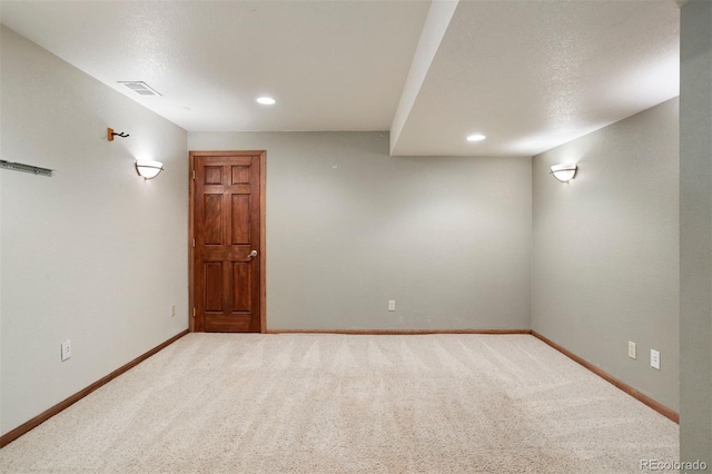 spare room with carpet and a textured ceiling