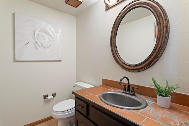 bathroom featuring hardwood / wood-style floors, vanity, and toilet