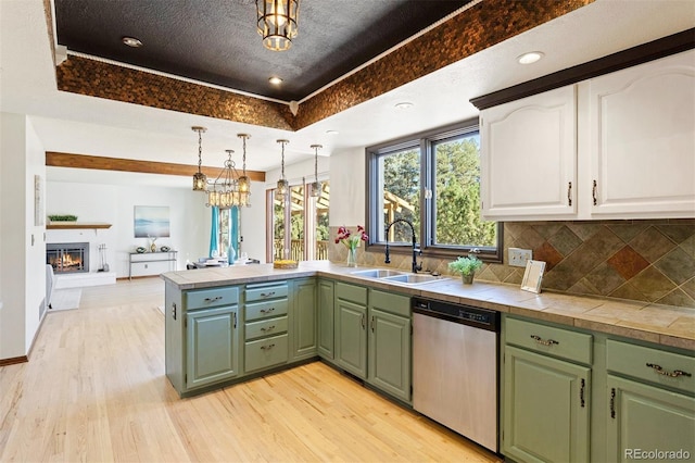 kitchen with dishwasher, sink, light hardwood / wood-style floors, pendant lighting, and white cabinets