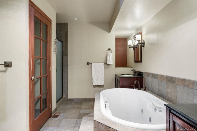 bathroom with vanity and independent shower and bath