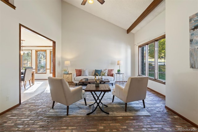 living room featuring ceiling fan and high vaulted ceiling