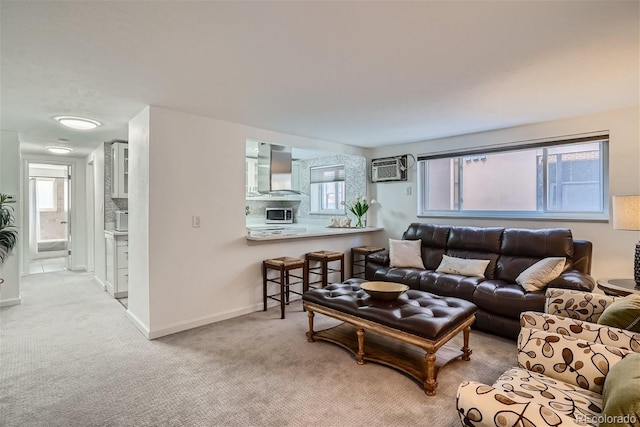 352 S Lafayette St Unit 204, Denver, CO 80209 - carpeted living area with an AC wall unit, plenty of natural light, and baseboards
