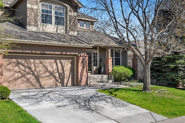 view of front facade featuring brick siding, a front yard, concrete driveway, and a garage