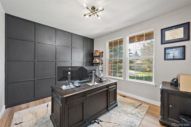 home office with baseboards and light wood finished floors