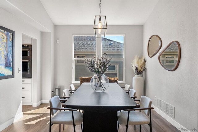 dining room with wood finished floors and baseboards