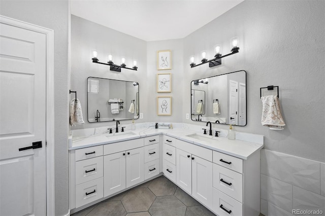 full bath featuring double vanity and tile patterned flooring