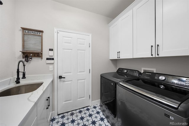 clothes washing area featuring cabinet space, washer and clothes dryer, and light floors