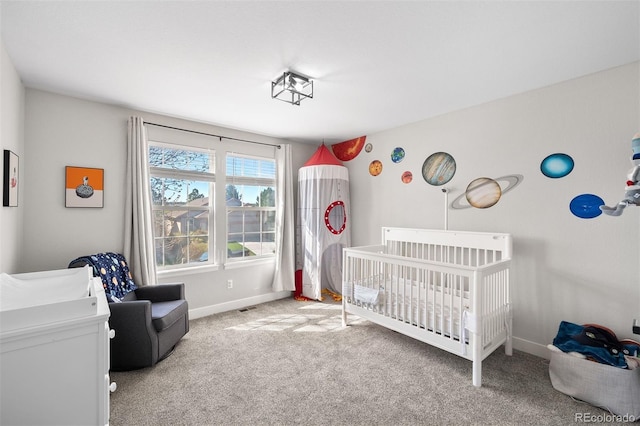 bedroom featuring a nursery area, carpet floors, and baseboards