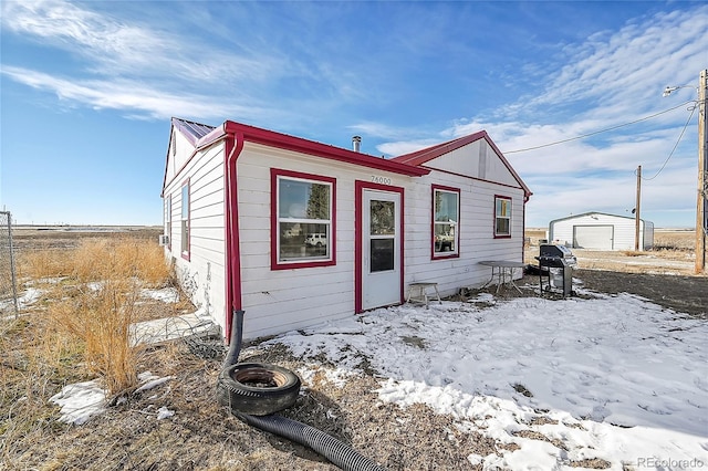 view of front of house with a garage and an outdoor structure