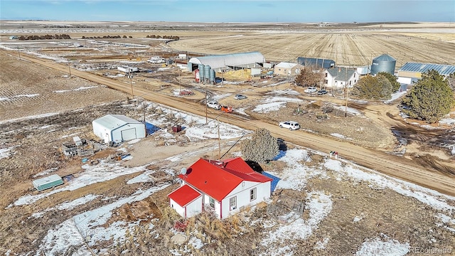 snowy aerial view featuring a rural view