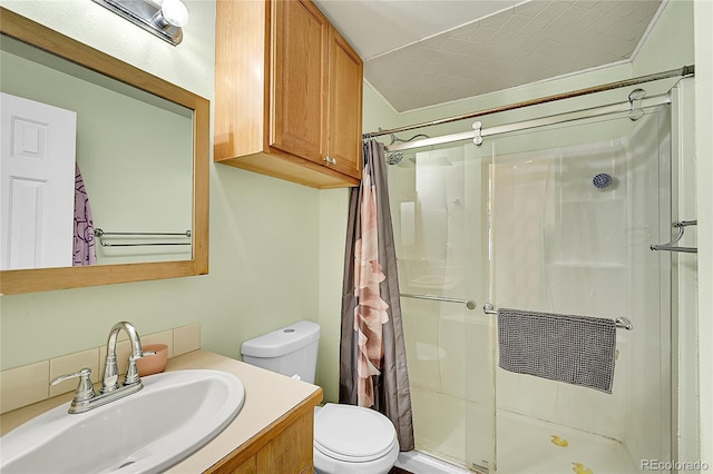 bathroom with a stall shower, toilet, and vanity