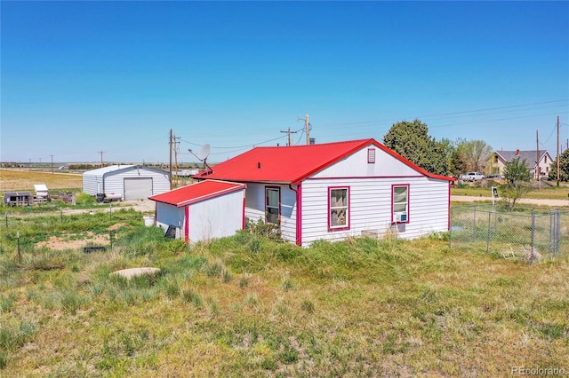 76000 E 168th Ave, Wiggins, CO 80654 - back of property featuring fence, an outdoor structure, metal roof, and cooling unit
