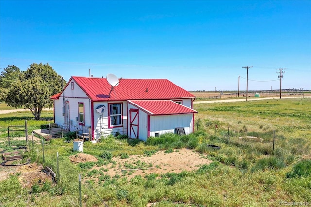76000 E 168th Ave, Wiggins, CO 80654 - view of front of house featuring metal roof and an outbuilding