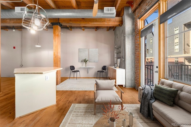 living area featuring wood finished floors and beam ceiling