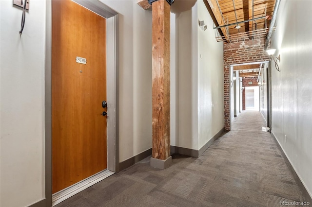 corridor with carpet flooring and baseboards
