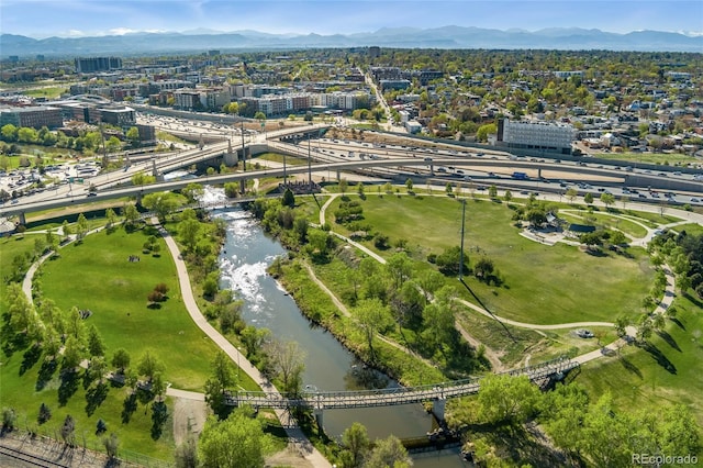 view of property location featuring a water and mountain view and nearby urban area