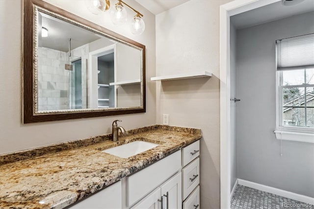 full bathroom with tiled shower, baseboards, and vanity