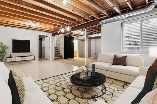 living area with tile patterned floors and stairs