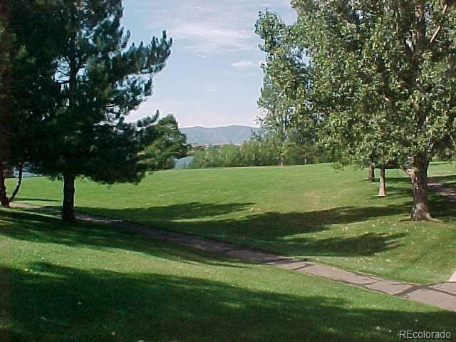 surrounding community featuring a mountain view and a yard