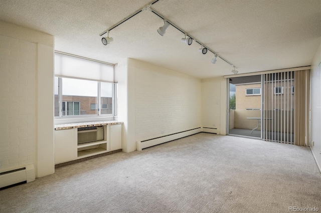 850 20th St Unit 203, Boulder, CO 80302 - unfurnished room featuring rail lighting, a baseboard heating unit, light carpet, and a textured ceiling