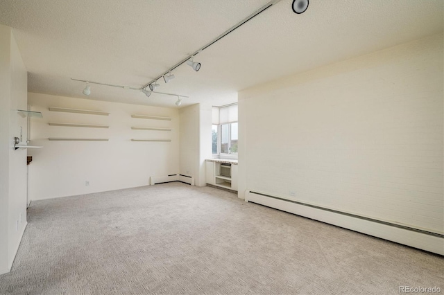 850 20th St Unit 203, Boulder, CO 80302 - empty room with a baseboard heating unit, light colored carpet, track lighting, and a textured ceiling