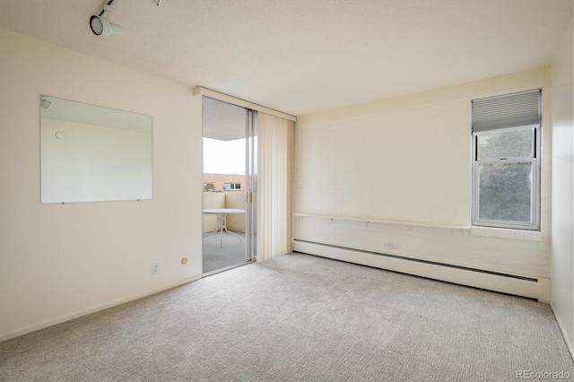 850 20th St Unit 203, Boulder, CO 80302 - carpeted empty room with a baseboard radiator and plenty of natural light