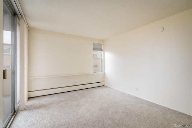 850 20th St Unit 203, Boulder, CO 80302 - unfurnished room with baseboard heating, carpet flooring, plenty of natural light, a textured ceiling, and a smoke detector