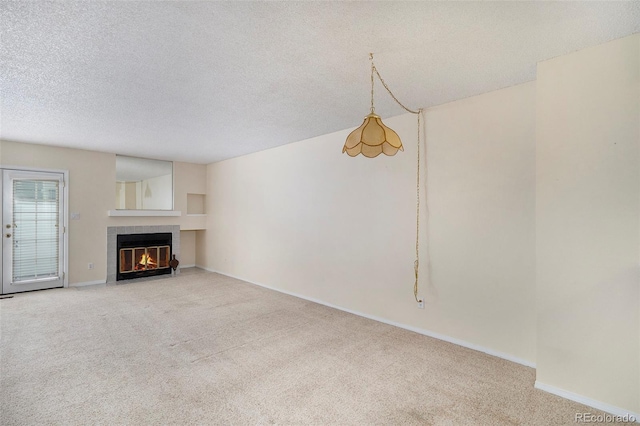 unfurnished living room with a fireplace, carpet, and a textured ceiling