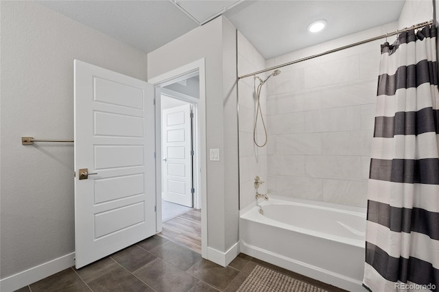 bathroom with tile patterned flooring and shower / tub combo