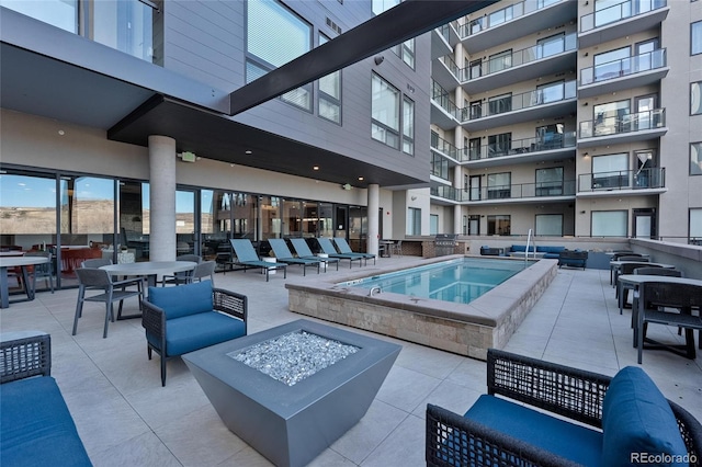 view of pool with a patio, a jacuzzi, and a fire pit