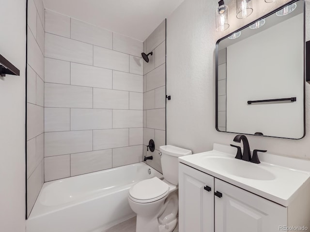 full bathroom with vanity, toilet, and tiled shower / bath